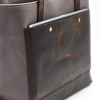 Gray bag with a tortoiseshell patterned flap on a white background