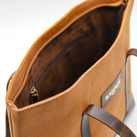 Brown leather bag with visible brand name on a white background