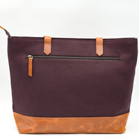 Brown tote bag with tan accents on a white background