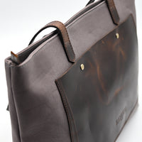Brown leather bag on a white background