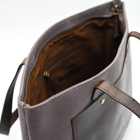 Gray tote bag with brown interior on a white background