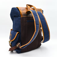 Blue backpack with brown leather accents on a white background