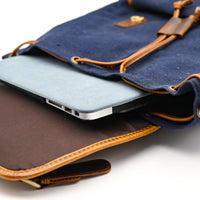 Blue and brown leather bag with a tablet inside on a white background