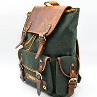 Green backpack with brown leather straps and accents on a white background