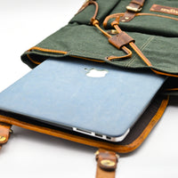 Green leather laptop sleeve with Apple logo on a white background