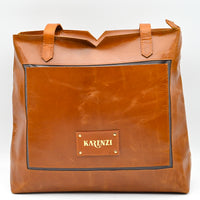 Brown leather tote bag with 'KARENZI' brand logo on a white background