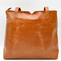 Brown leather tote bag on a white background