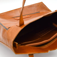 Brown leather bag on a white background