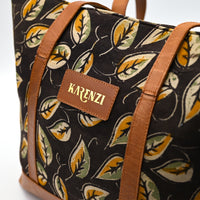 Bag with leaf pattern and 'KARENZI' brand label on a white background