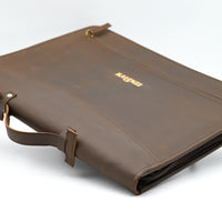 Brown leather briefcase with gold zipper on a white background