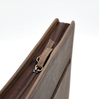 Brown leather clutch bag with zipper on a white background