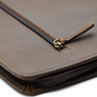 Brown leather portfolio with zipper on a white background