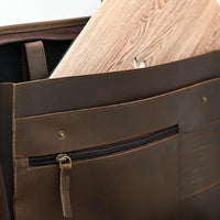 Brown leather bag with a wooden panel on a white background