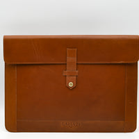 Brown leather briefcase with a visible brand logo on a white background