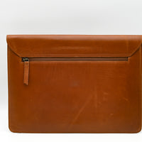 Brown leather pouch with a zipper on a white background