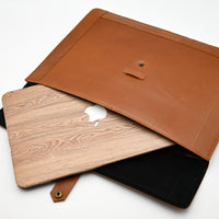 Brown leather laptop sleeve with wooden back on a white background