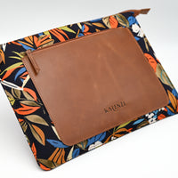 Floral-patterned pouch with brown leather flap and 'KARENZI' branding on a white background