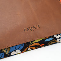 Brown leather pouch with floral pattern underneath, featuring the brand 'KARENZI'.