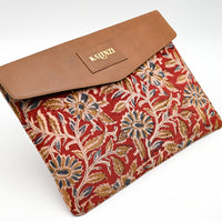 Floral patterned pouch with brown flap on a white background