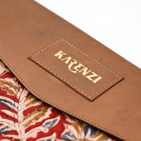 Brown leather strap with 'KARENZI' logo on a floral fabric background