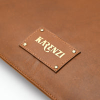 Brown leather surface with 'KRENZI' label