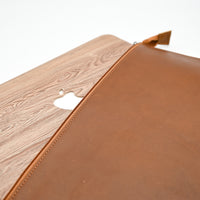 Brown leather case with wooden back on a white background